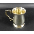 An Elizabeth II silver tankard, of baluster form, with rococo scroll handle and thumbpiece, Deakin &... 