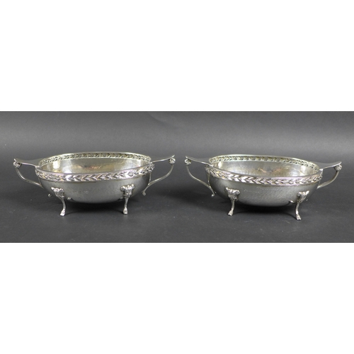 53 - A pair of silver George V twin handled oval form planished bowls, with presentation inscription to '... 