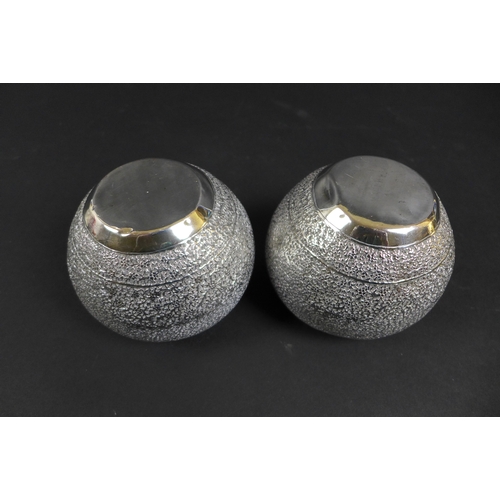 47 - A pair of early 20th century Indian white metal spherical bowls with profuse foliate engraving, on c... 