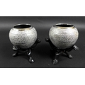 A pair of early 20th century Indian white metal spherical bowls with profuse foliate engraving, on c... 