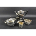 An Edwardian silver four piece tea and coffee service, of pedestal form with half reeded bodies, com... 