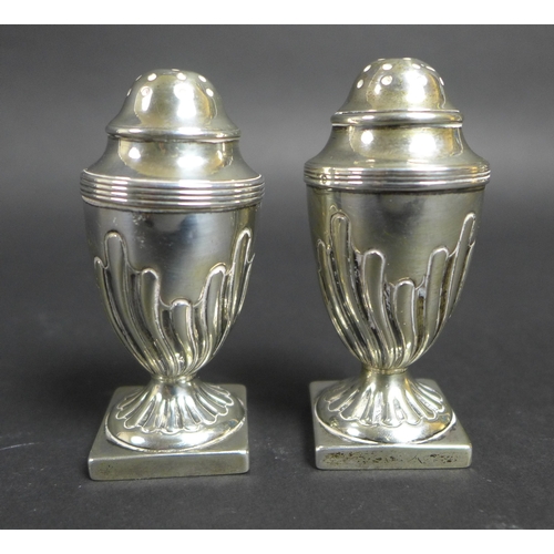 51 - A group of nine silver items, comprising a pair of octagonal form pepper pots, James Deakin & Sons, ... 