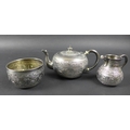 A Victorian silver three piece tea service, decorated after Indian Mughal style and embossed with ni... 