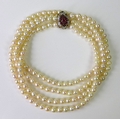 A two strand pearl necklace with 9ct gold ruby and diamond clasp, the pearls approximately 5mm diame... 