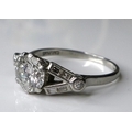 An Art Deco diamond and platinum ring, the central brilliant cut diamond of approximately 1.4ct, fla... 