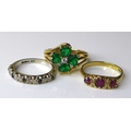 Three 9ct gold rings, comprising an early 20th century three stone ruby ring, size M, a white gold, ... 