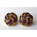 A pair of 9ct gold ruby knot form earrings, set with twelve oval brilliant cut rubies, London import... 