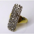 A diamond cluster ring inlaid with small baguette cut stones on an 18ct gold plated silver band, siz... 