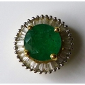 An 18ct gold emerald and diamond pendant, the round cut emerald of 6mm diameter surrounded by approx... 