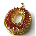 A 9ct gold and sunset ruby oval pendant, set with twenty four marquise cut rubies, each approximatel... 