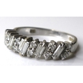 An 18ct white gold and diamond ring, five baguette cut stones, each 4 by 2mm, set alternately with s... 