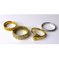 A group of four rings, comprising a platinum wedding band, size N, 3.8g, an 18ct white and yellow go... 