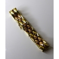 A 9ct bicoloured gold bracelet, composed of yellow and rose gold lozenge shaped panels, 18.5cm long,... 