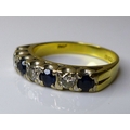 An 18ct gold sapphire and diamond ring, composed of seven alternating stones, size M/N, 4.4g.