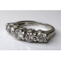 A platinum and diamond five stone designer ring, the central diamond of approximately 0.25ct, flanke... 