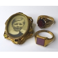Two 9ct gold gentlemans' rings, one claw set with an oval cut garnet, size P, the other with a squar... 
