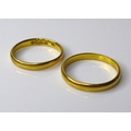 Two 22ct gold wedding bands, size M and size J, 4.9g total weight. (2)