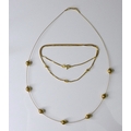 An 18ct gold necklace with delicate knot detailing, 4.5g, together with a decorative 9ct gold neckla... 