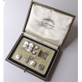A set of gentleman's 9ct white gold dress studs, with mother of pearl and seed pearls to the centre,... 