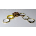 A group of six gold gold rings, comprising a 22ct gold wedding band size S, 3.6g, three 18ct gold an... 