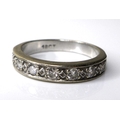 An 18ct with gold and diamond half eternity ring, the rubover setting with seven diamonds, 5.8g, siz... 