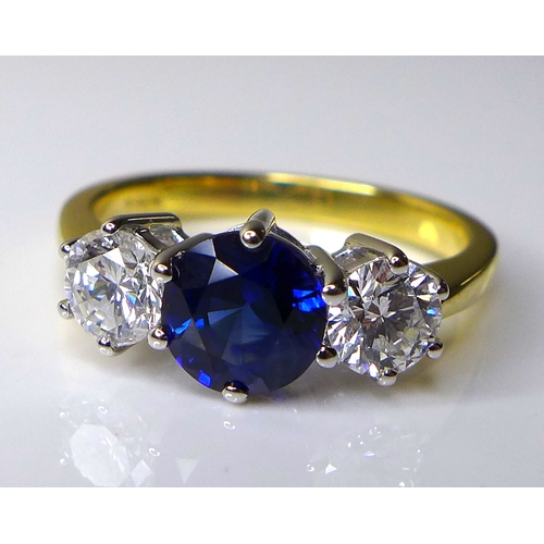 337 - An 18ct gold, diamond and sapphire three stone ring,  with central sapphire of approximately 1.2ct, ... 