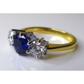 An 18ct gold, diamond and sapphire three stone ring,  with central sapphire of approximately 1.2ct, ... 
