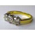 An 18ct gold and diamond three stone ring, each stone approximately 5mm diameter, total diamond weig... 