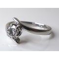 A platinum and diamond solitaire ring of contemporary swirl design, diamond of approximately 0.5ct, ... 