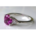 An 18ct white gold, pink sapphire and diamond dress ring, the central sapphire of approximately 1.4c... 