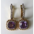 A pair of 18ct white and rose gold, amethyst and diamond earrings, with central cushion cut amethyst... 