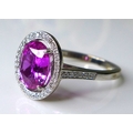An impressive, 18ct white gold, pink sapphire and diamond dress ring, the large oval cut deep rose c... 