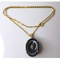 A 19th century French mourning pendant of black bull's eye agate set with a central seed pearl in a ... 