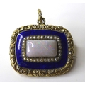 A late 19th century mourning brooch set with a central opal, surrounded by seed pearls and blue enam... 