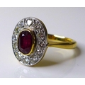 An 18ct gold, ruby and diamond dress ring, the central oval cut stone of approximately 0.75ct, 6.31 ... 