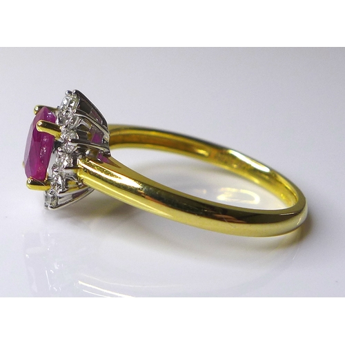 310 - An 18ct gold, ruby and diamond ring, the oval cut ruby, of approximately 0.75ct, 7 by 5.04mm approxi... 