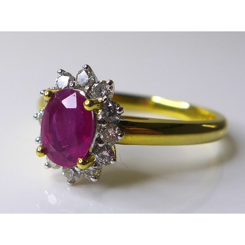 310 - An 18ct gold, ruby and diamond ring, the oval cut ruby, of approximately 0.75ct, 7 by 5.04mm approxi... 