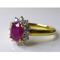 An 18ct gold, ruby and diamond ring, the oval cut ruby, of approximately 0.75ct, 7 by 5.04mm approxi... 