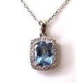 An 18ct white gold, aquamarine and diamond pendant, the central cushion cut aquamarine of approximat... 