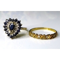 A 9ct gold sapphire cluster ring, the pear cut central sapphire 6mm long, surrounded by five illusio... 