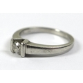 A platinum and diamond solitaire ring, the 0.2ct diamond in a deep V setting with bars to either sid... 