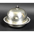 A George V silver muffin dish, of circular domed form, with black plastic finial, removable tray, an... 