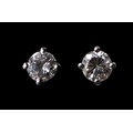 A pair of platinum and diamond stud earrings, each set with a single exceptionally white and clear d... 