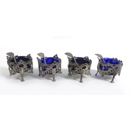 59 - A William IV / early Victorian silver set of four salt cellars, of circular pierced floral swag desi... 