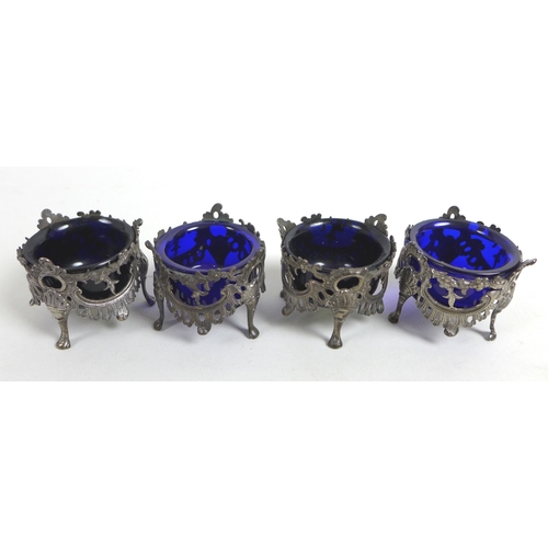 59 - A William IV / early Victorian silver set of four salt cellars, of circular pierced floral swag desi... 