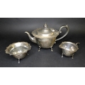 An Edwardian silver three piece tea set, comprising a squat form teapot with ebonised finial and han... 