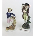 An early 19th century Staffordshire pottery figure, modelled as a shepherd carrying a sheep over his... 