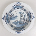 An 18th century Delft pottery tin glazed dish, decorated in blue and white in Chinese style, 35 by 6... 