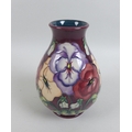 A Moorcroft pottery pansy pattern baluster vase, with initialled 'WM' and impressed diamond date mar... 