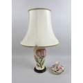 A Moorcroft pink magnolia pattern table lamp with wooden stand, lamp base only 13.5 by 29cm high and... 